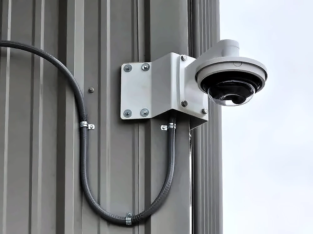 Multi-sensor dome camera on a corner bracket with the cable run in conduit